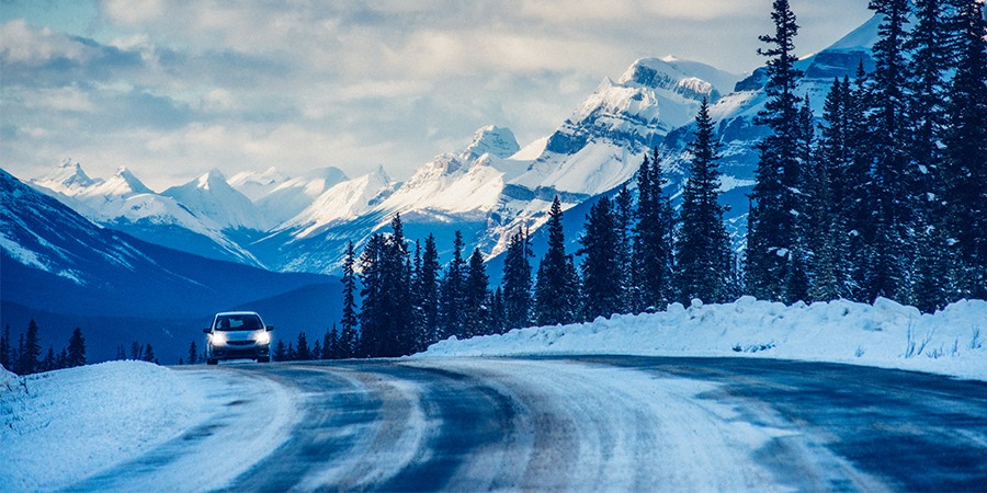 Car-On-Snowy-Road-With-Headlights-On-Thumbnail